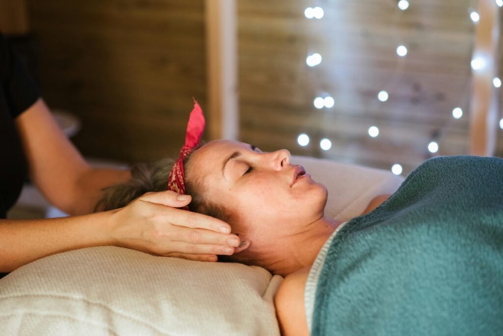 pexels photo 5240700 5240700 Side view of relaxed female patient with closed eyes lying on table under blanket while getting massage reiki during healing session in salon