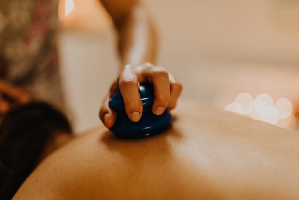 pexels photo 6629523 6629523 Close-up of cupping therapy on a person's back, focusing on relaxation and wellness.
